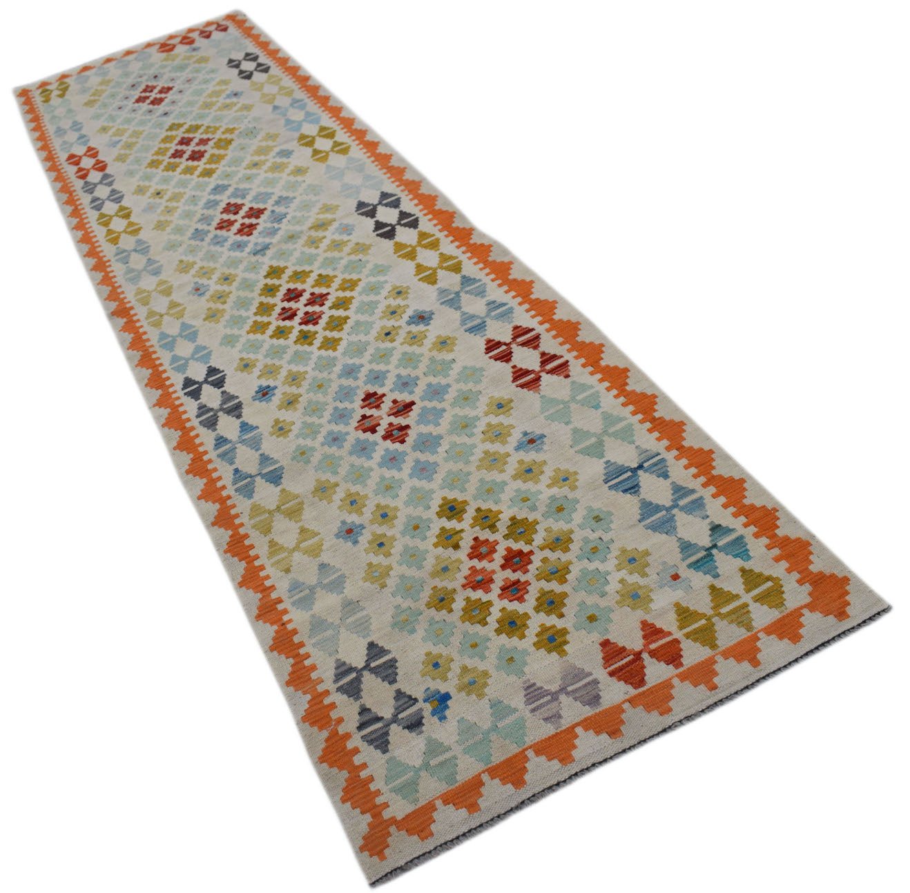 A handmade Afghan Maimana wool runner rug featuring a geometric pattern in vibrant colors.