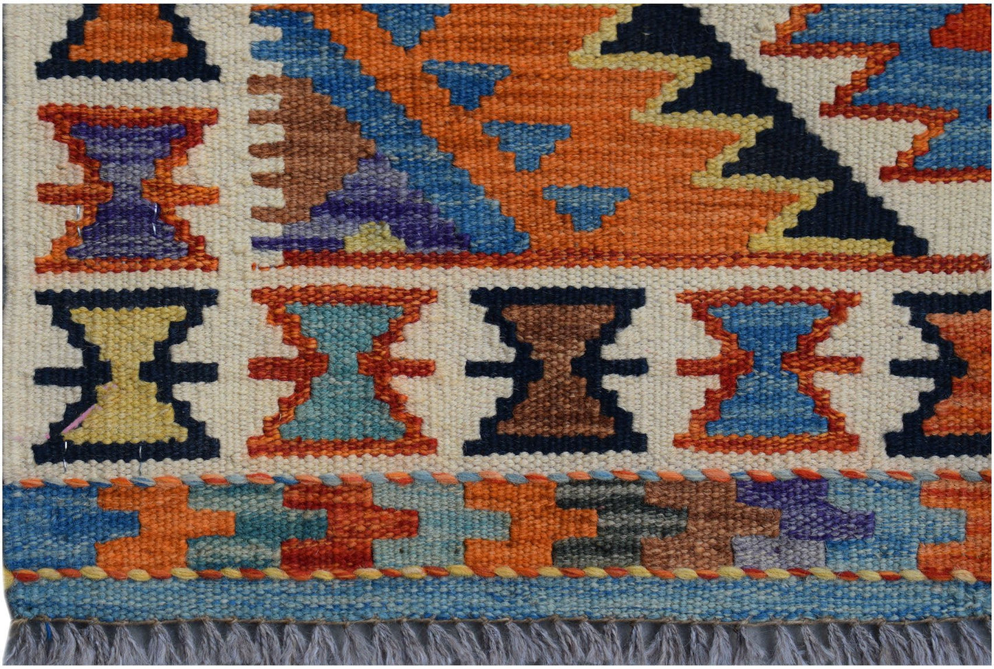 Handwoven Afghan Maimana wool kilim runner featuring colorful geometric patterns and fringe ends.
