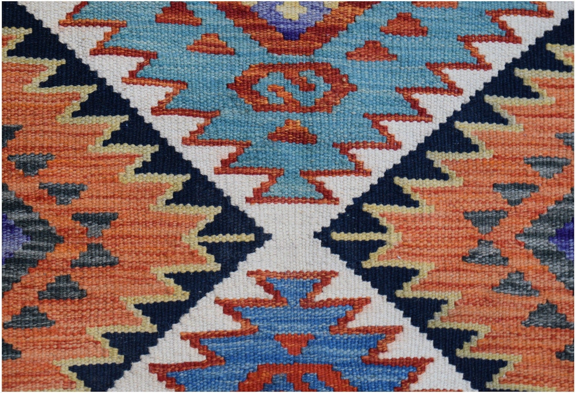 Handwoven Afghan Maimana kilim runner featuring a geometric pattern in blue, orange, and cream.