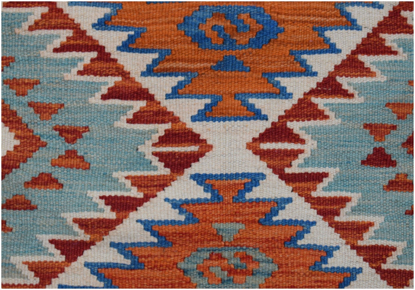 Handwoven Afghan Maimana wool runner featuring a geometric pattern in orange, blue, and cream.