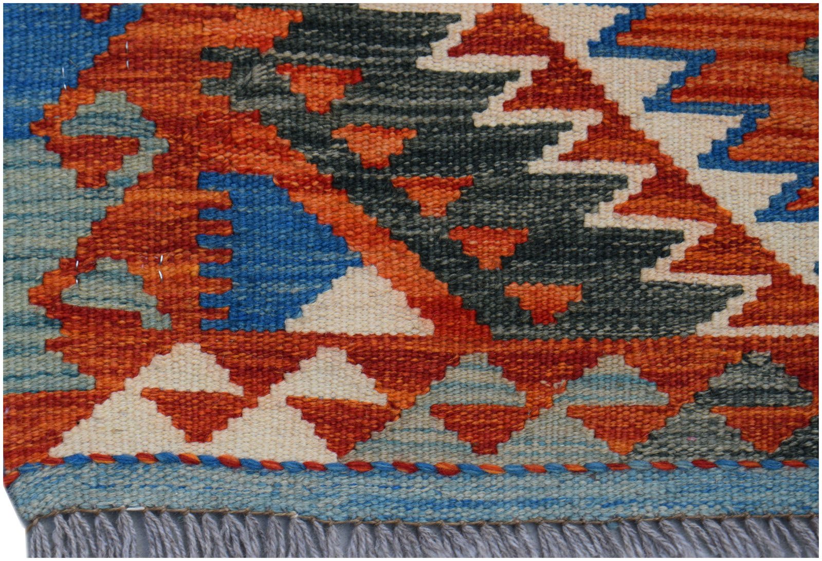 A handwoven Afghan Maimana wool kilim runner featuring a geometric pattern in orange and blue.