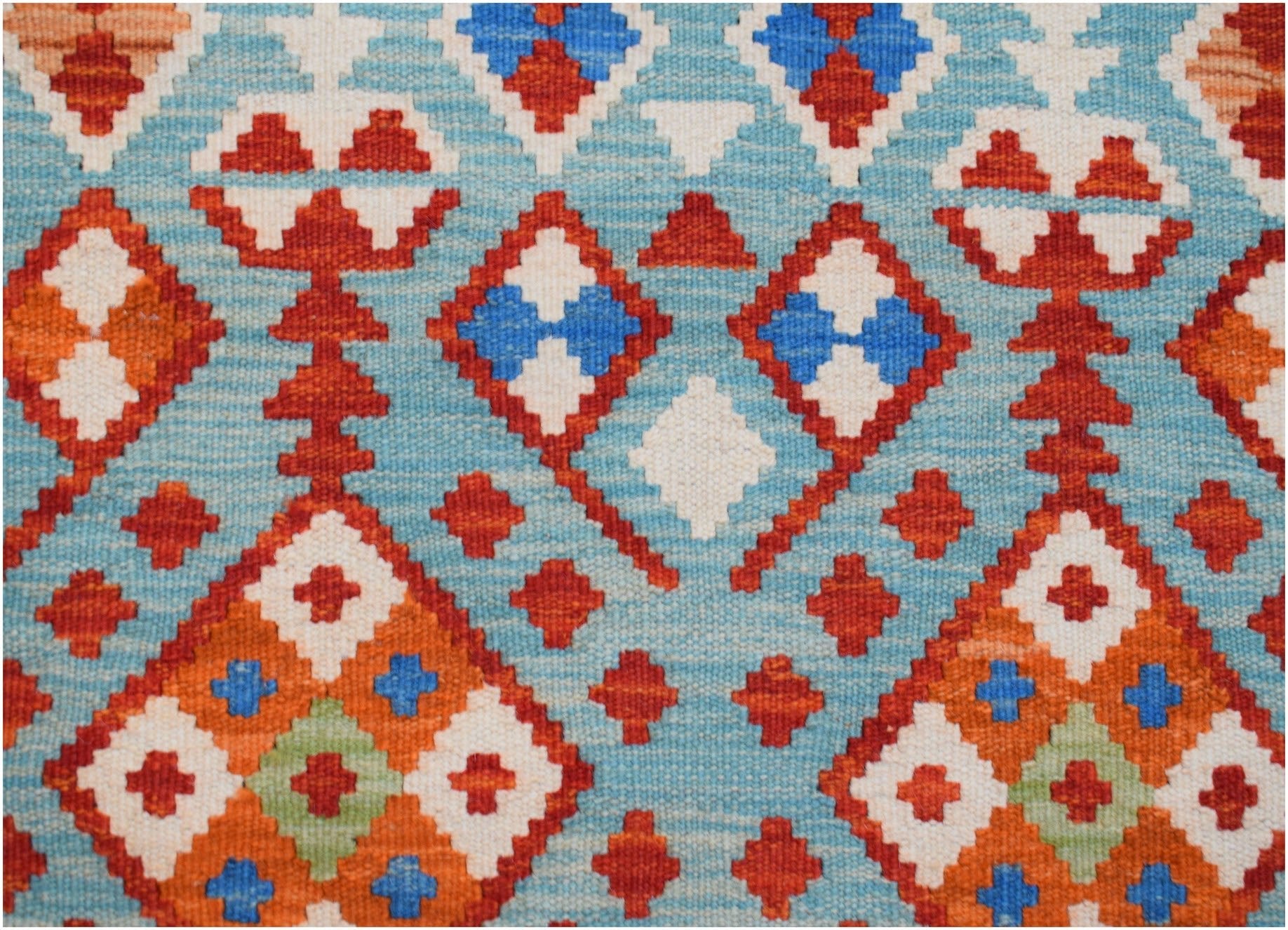 Handwoven Afghan Maimana kilim runner featuring a geometric pattern in blue, orange, and white.