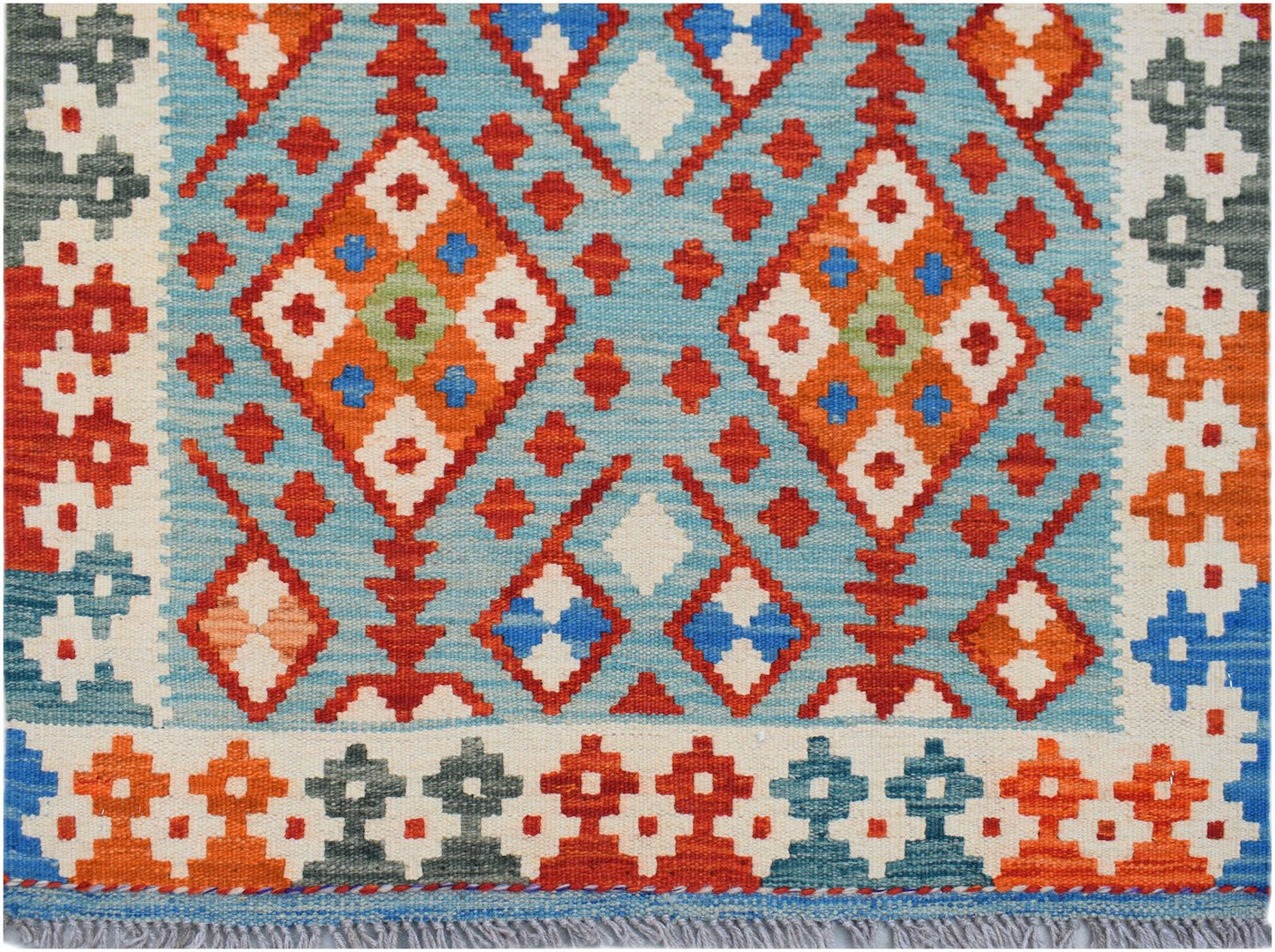 Handwoven Afghan Maimana wool runner featuring a geometric diamond pattern in blue and orange.