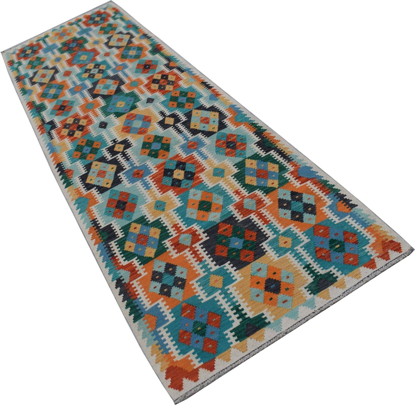 A handmade Afghan Maimana wool runner rug featuring a colorful geometric pattern.