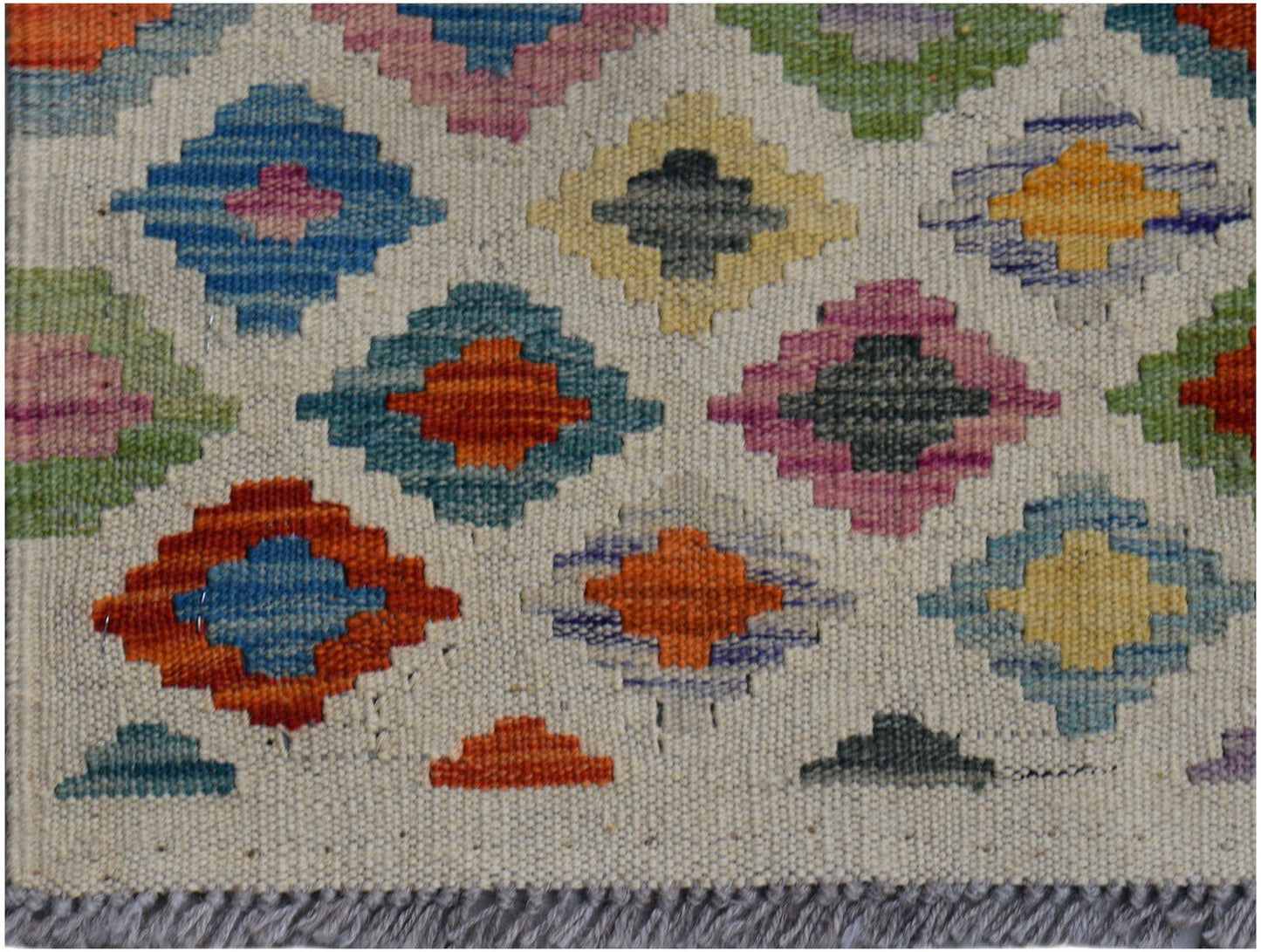 Handwoven Afghan Maimana wool runner featuring a colorful geometric diamond pattern.