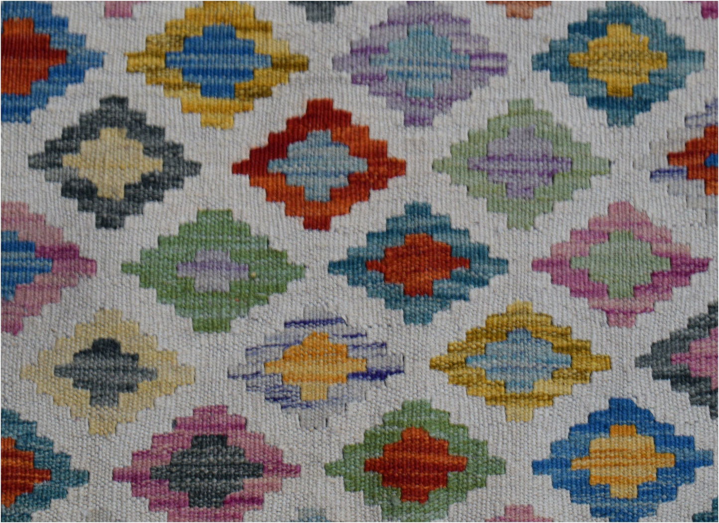 Handwoven Afghan Maimana wool kilim runner featuring a repeating pattern of colorful diamonds.