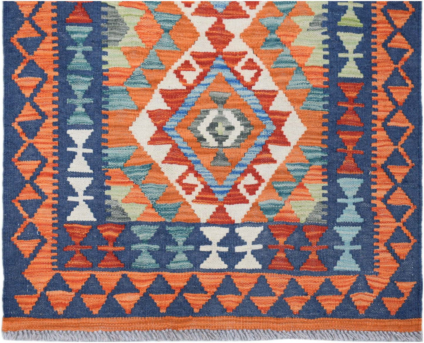 Handwoven Afghan Maimana wool runner rug featuring a geometric pattern in blue and orange.