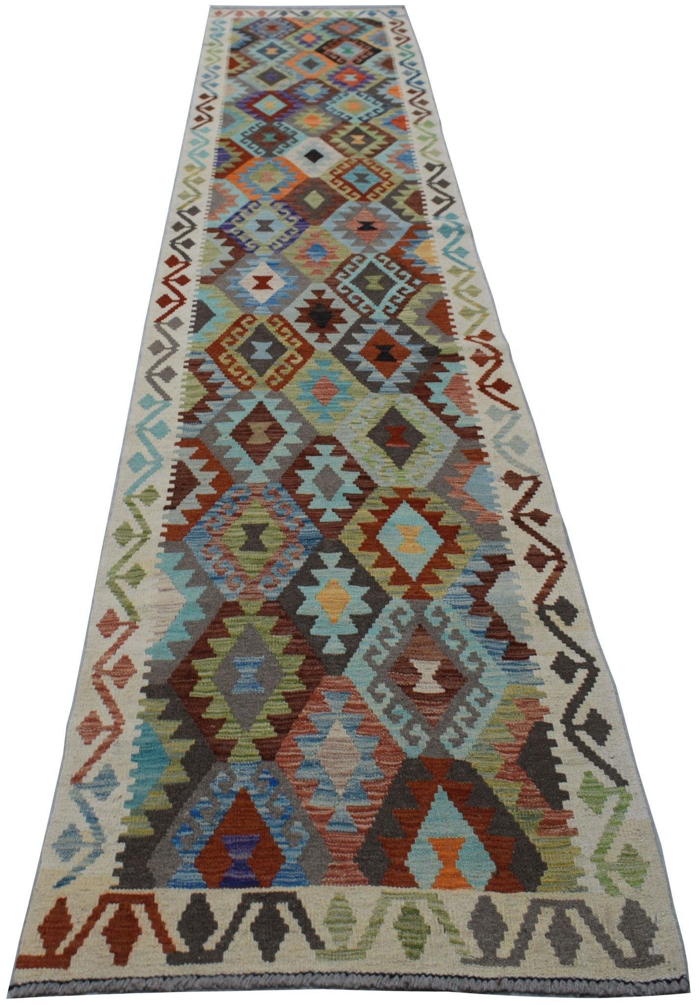 A handmade Afghan Maimana wool runner rug featuring a colorful geometric diamond pattern.