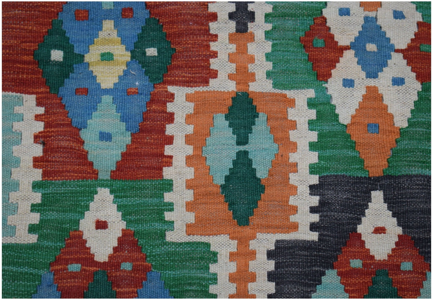 Handwoven Afghan Maimana kilim runner featuring a vibrant geometric pattern in wool.