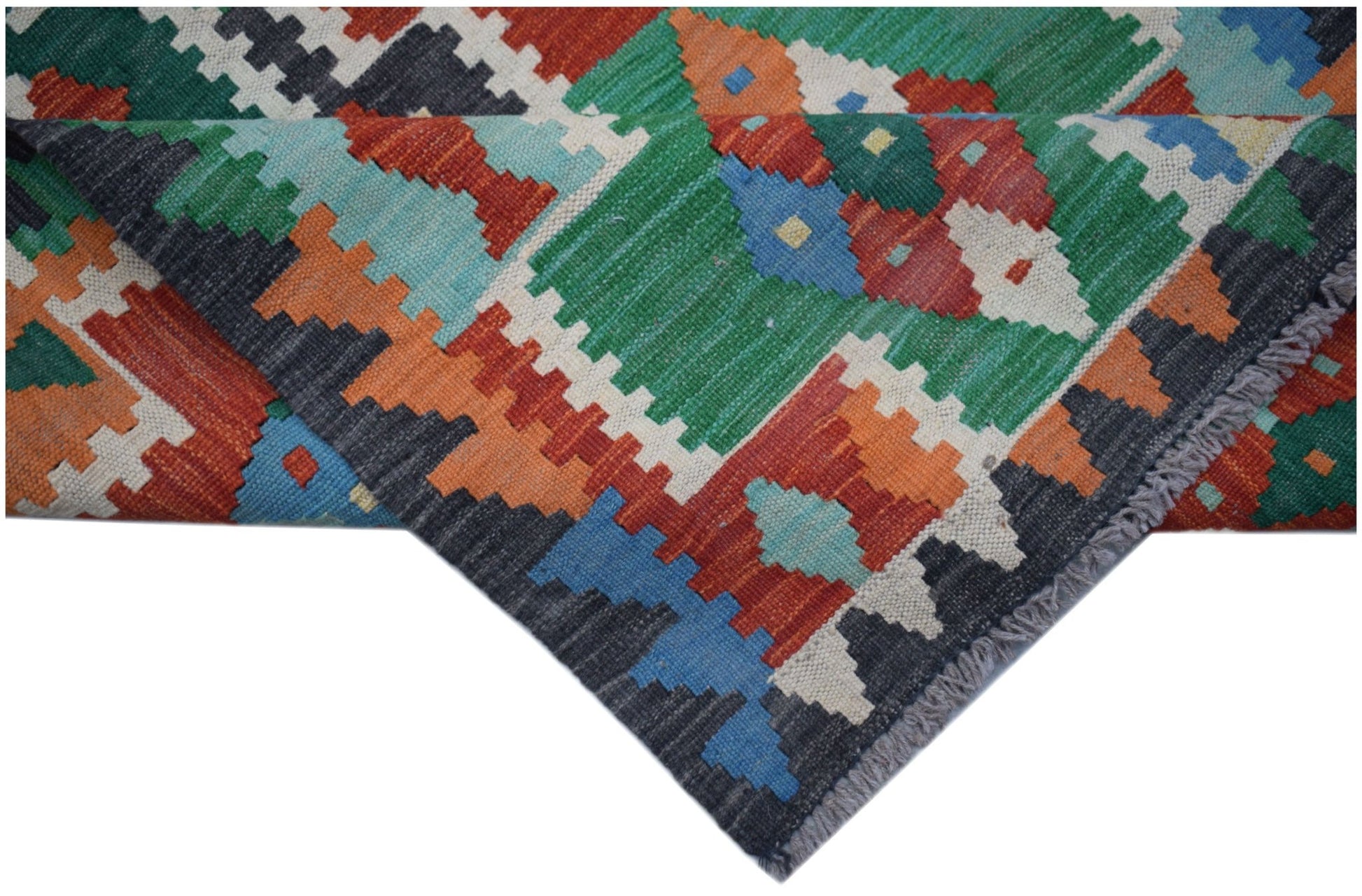 A handmade Afghan Maimana kilim runner featuring a vibrant geometric pattern in wool.