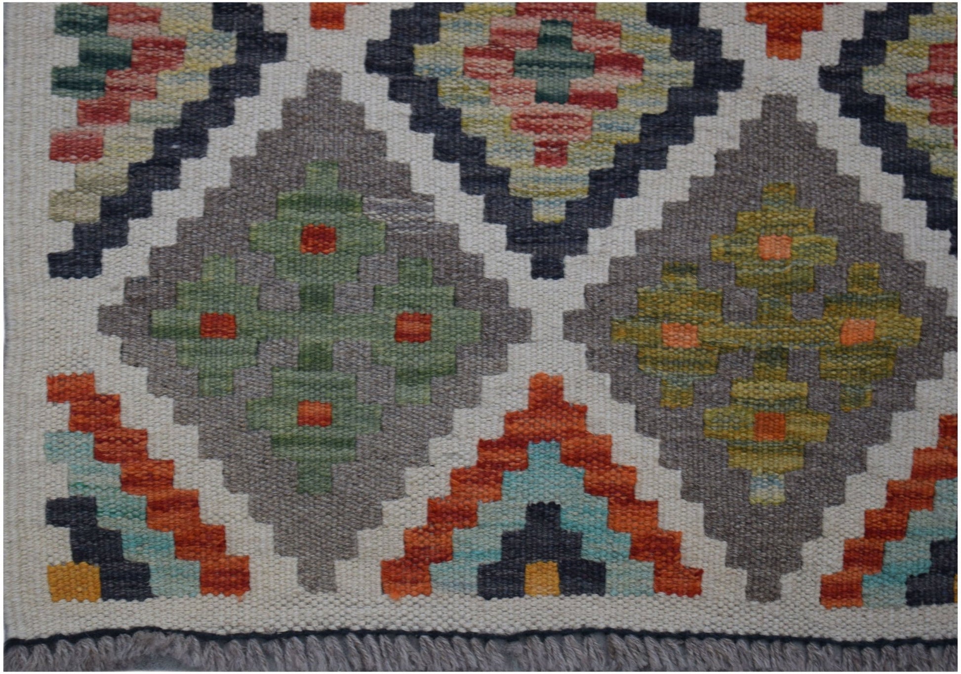 Handwoven Afghan Maimana kilim runner featuring a geometric diamond pattern in earthy tones.