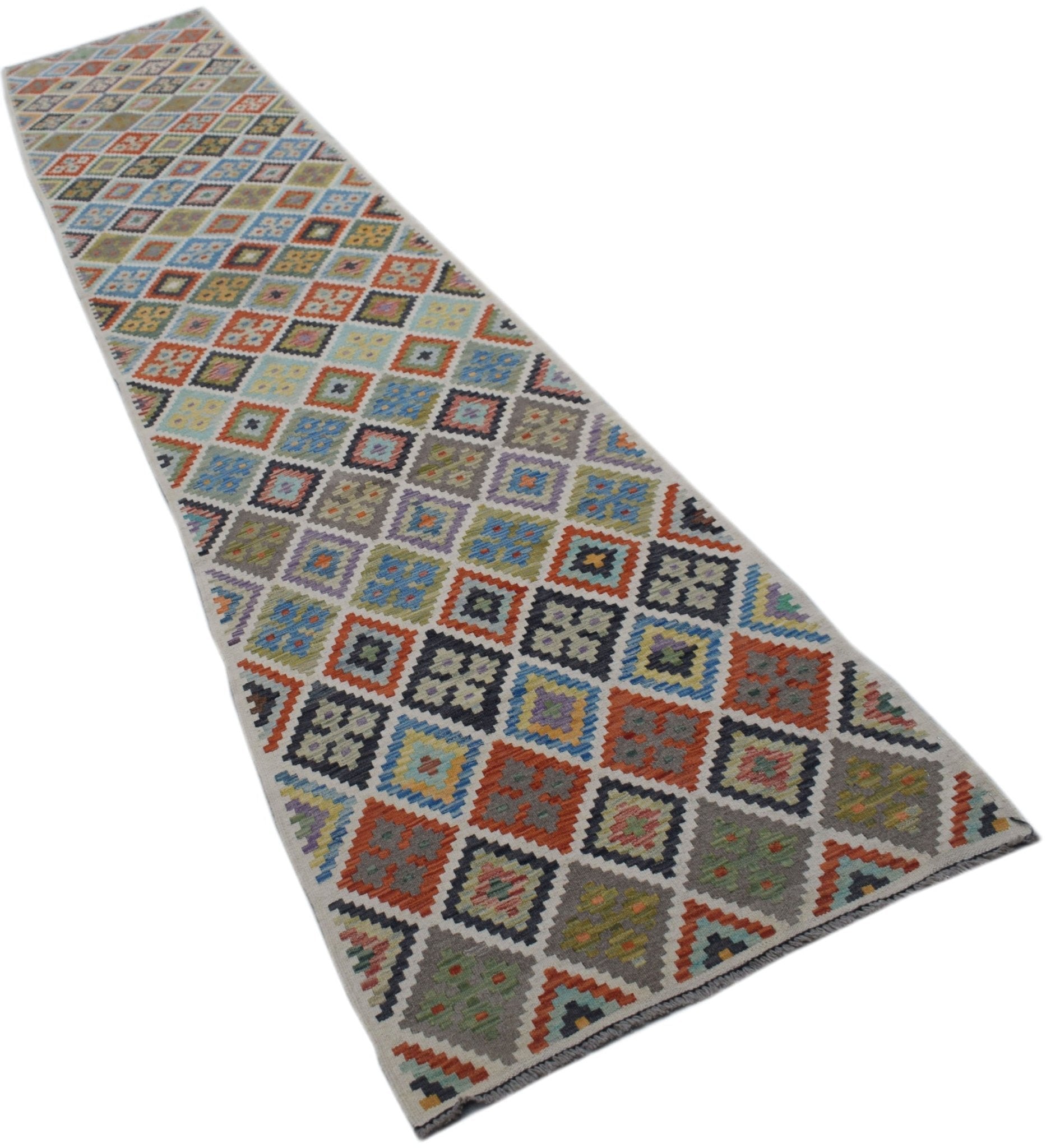 A long, handmade Afghan Maimana wool runner rug featuring a colorful geometric diamond pattern.