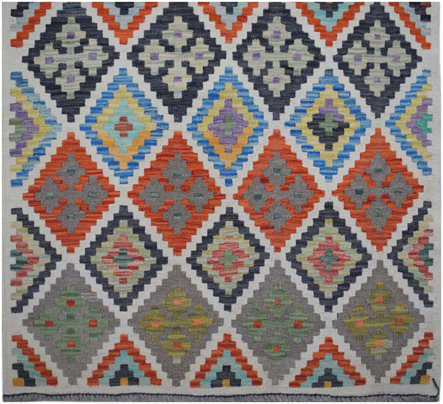 Handwoven Afghan Maimana wool runner featuring a colorful geometric diamond pattern.