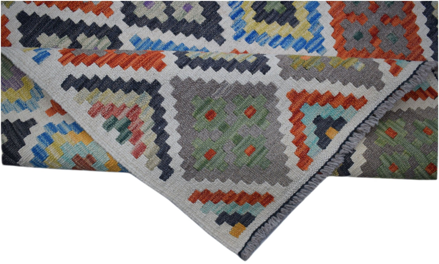 A handmade Afghan Maimana Kilim runner featuring a colorful geometric pattern on wool.