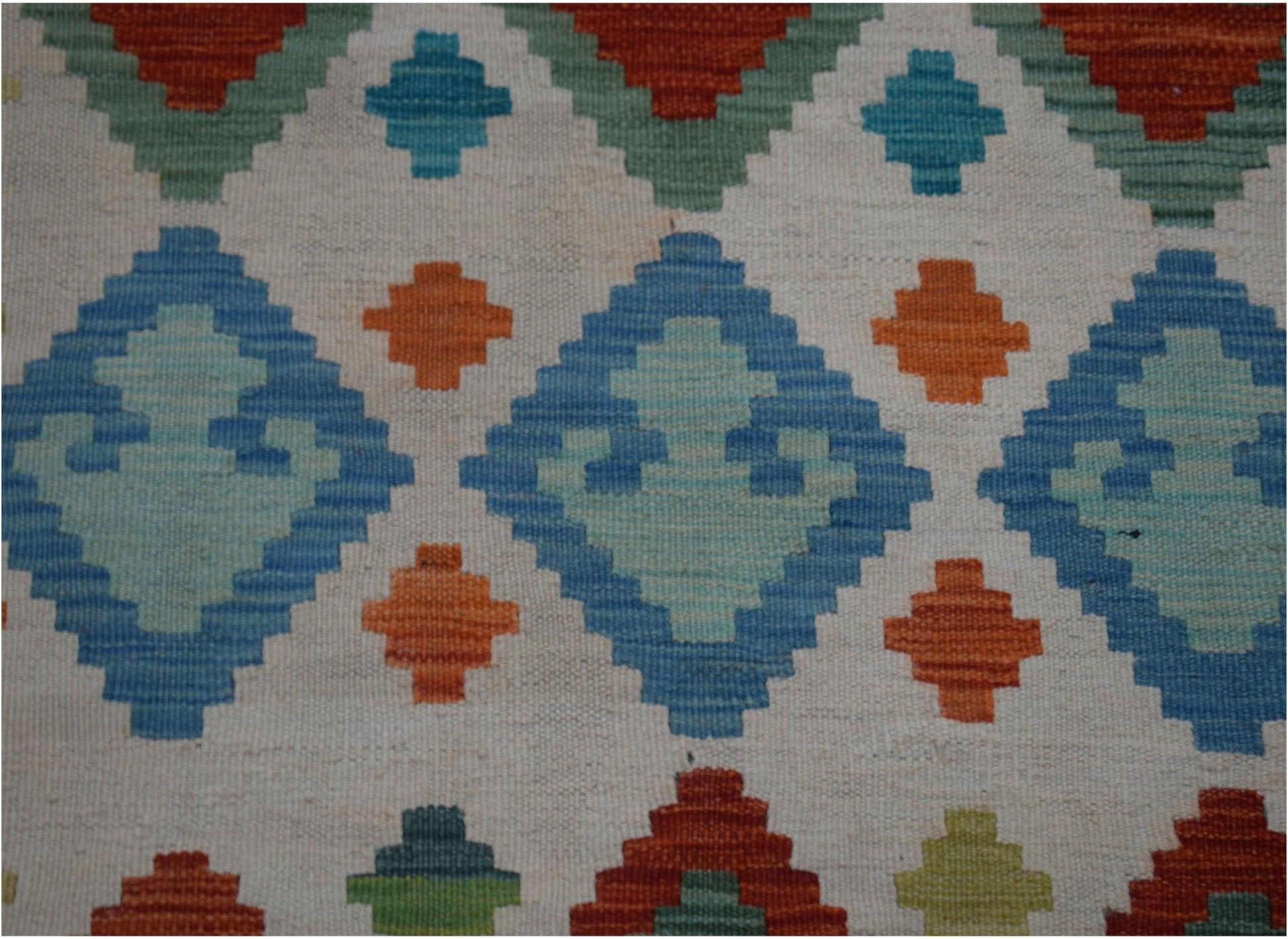 Handwoven Afghan Maimana kilim runner featuring a geometric pattern in blue, orange, and green.