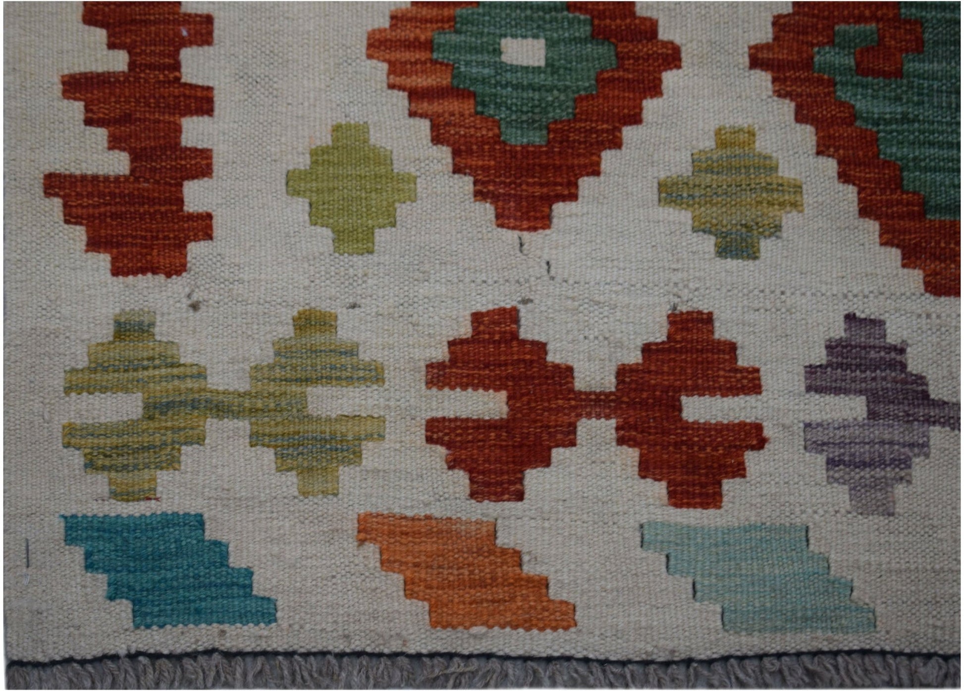 Handwoven Afghan Maimana kilim runner featuring a cream background with colorful geometric motifs.