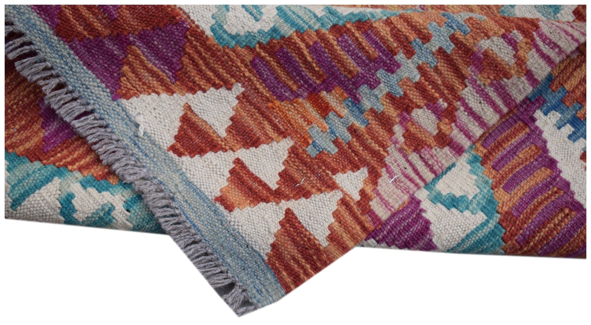 A handwoven Afghan Maimana kilim runner featuring geometric patterns in orange, purple, and blue.