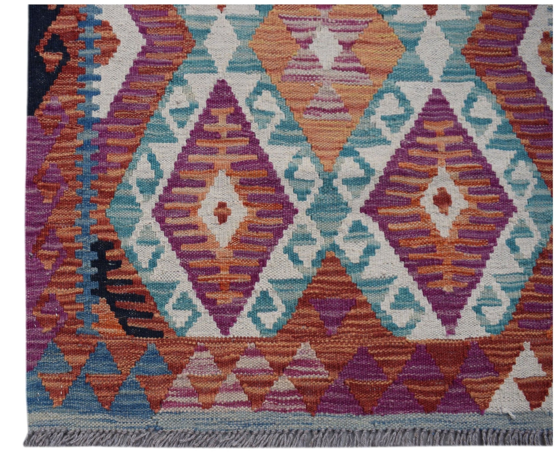 Handwoven Afghan Maimana wool runner featuring a vibrant geometric diamond pattern.