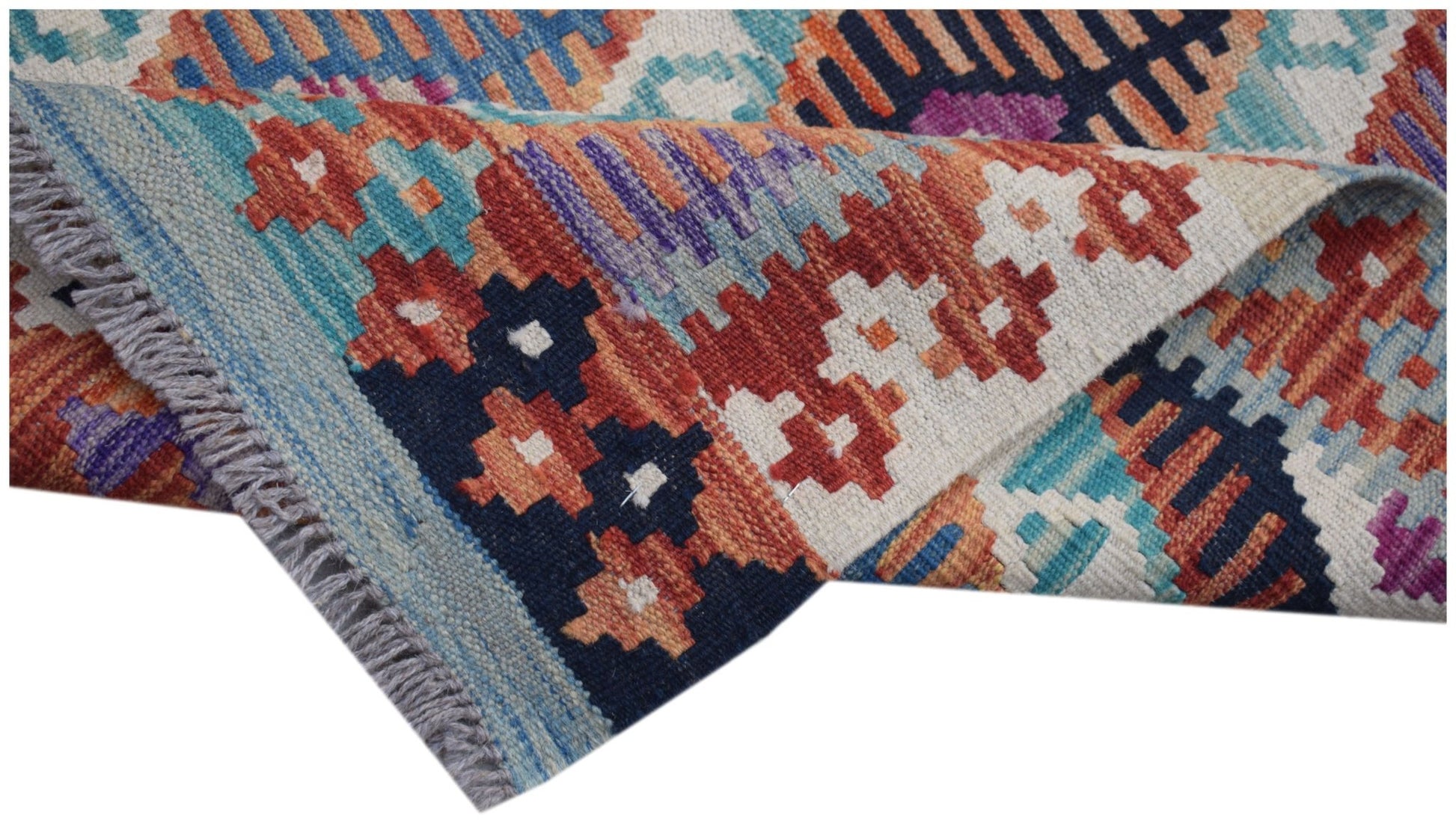 A handmade Afghan Maimana kilim runner featuring a vibrant geometric pattern in wool.