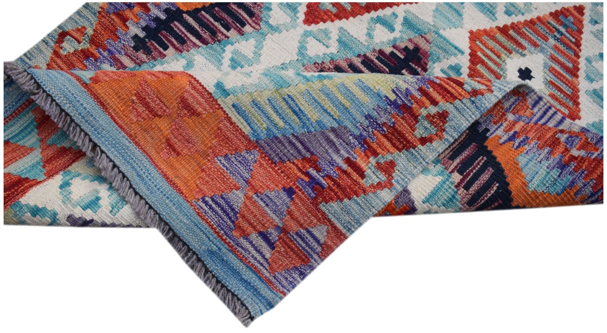 A handmade Afghan Maimana Kilim runner featuring vibrant geometric patterns in wool.