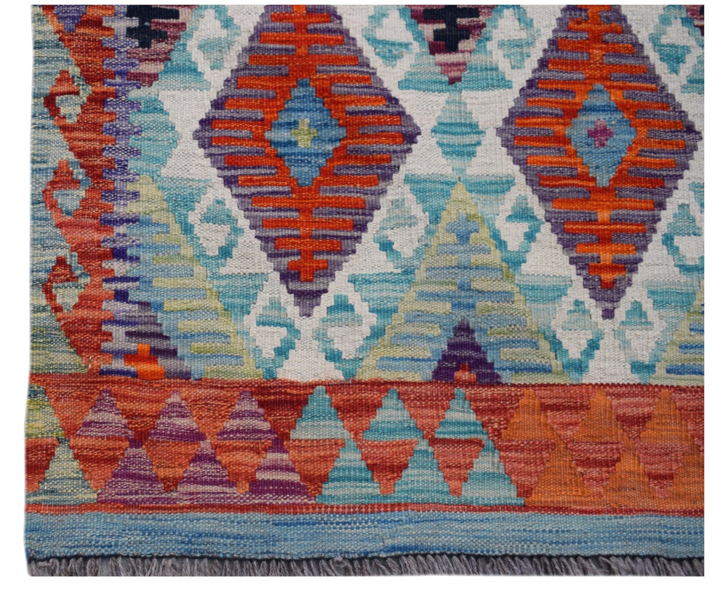 Handwoven Afghan Maimana kilim runner featuring a vibrant geometric pattern in wool.
