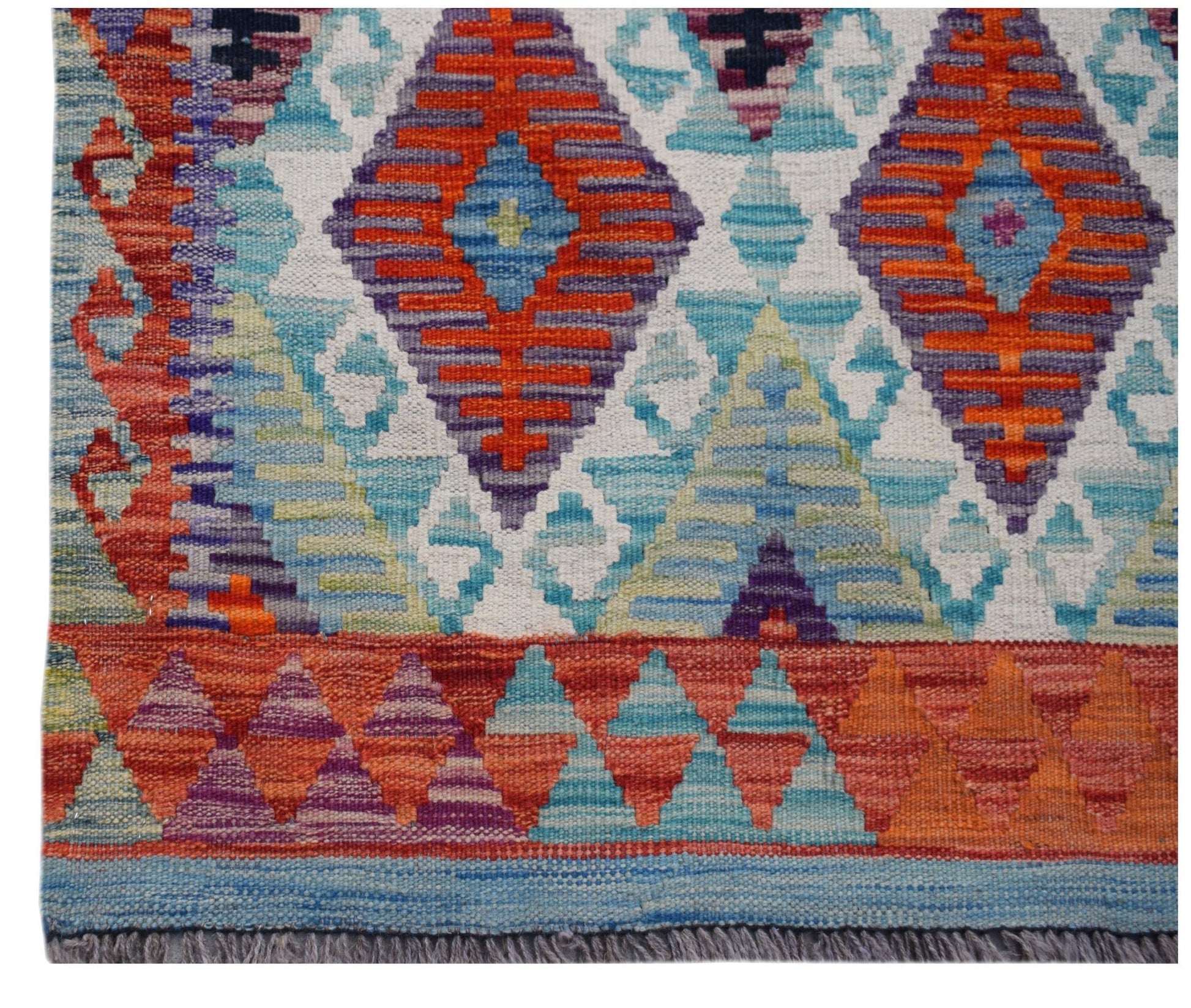 Handwoven Afghan Maimana kilim runner featuring a vibrant geometric pattern in wool.