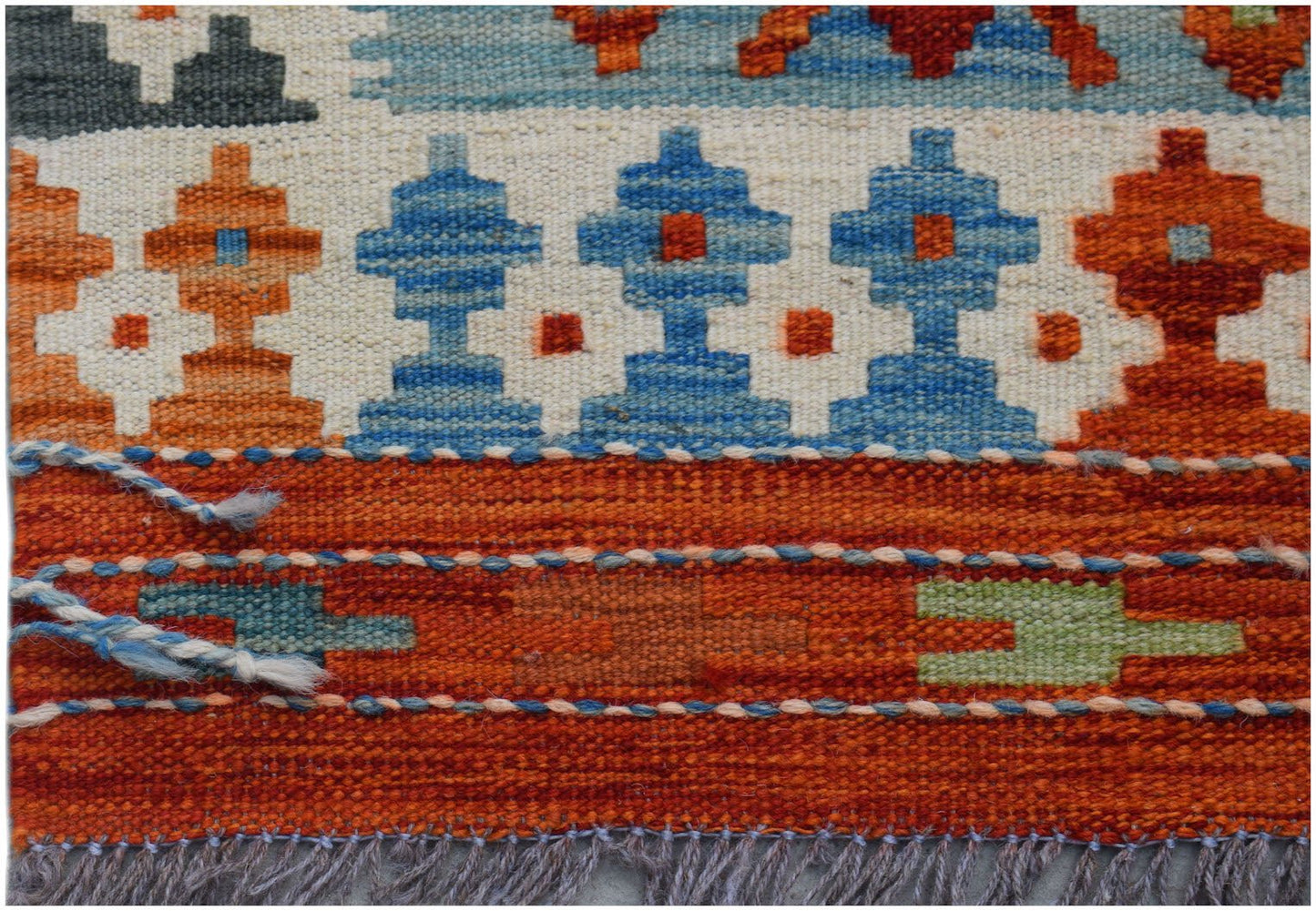 Handwoven Afghan Maimana kilim runner featuring geometric patterns in orange, blue, and cream.