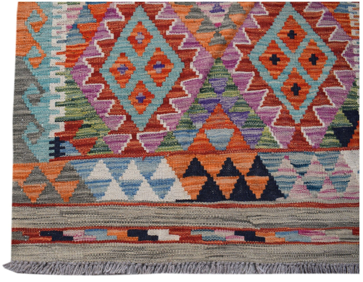 Handwoven Afghan Maimana kilim runner featuring vibrant geometric diamond patterns in wool.