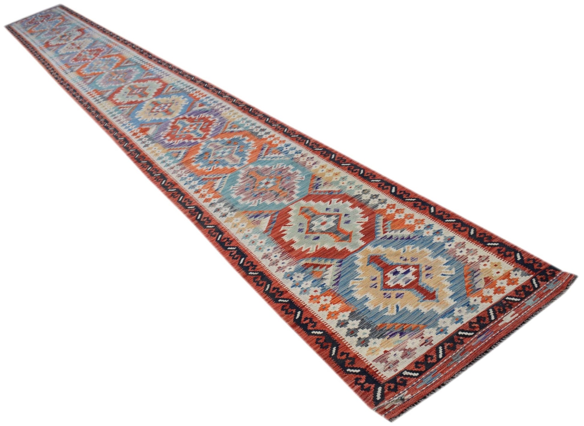 A long, handwoven Afghan Maimana wool runner featuring a colorful geometric pattern.