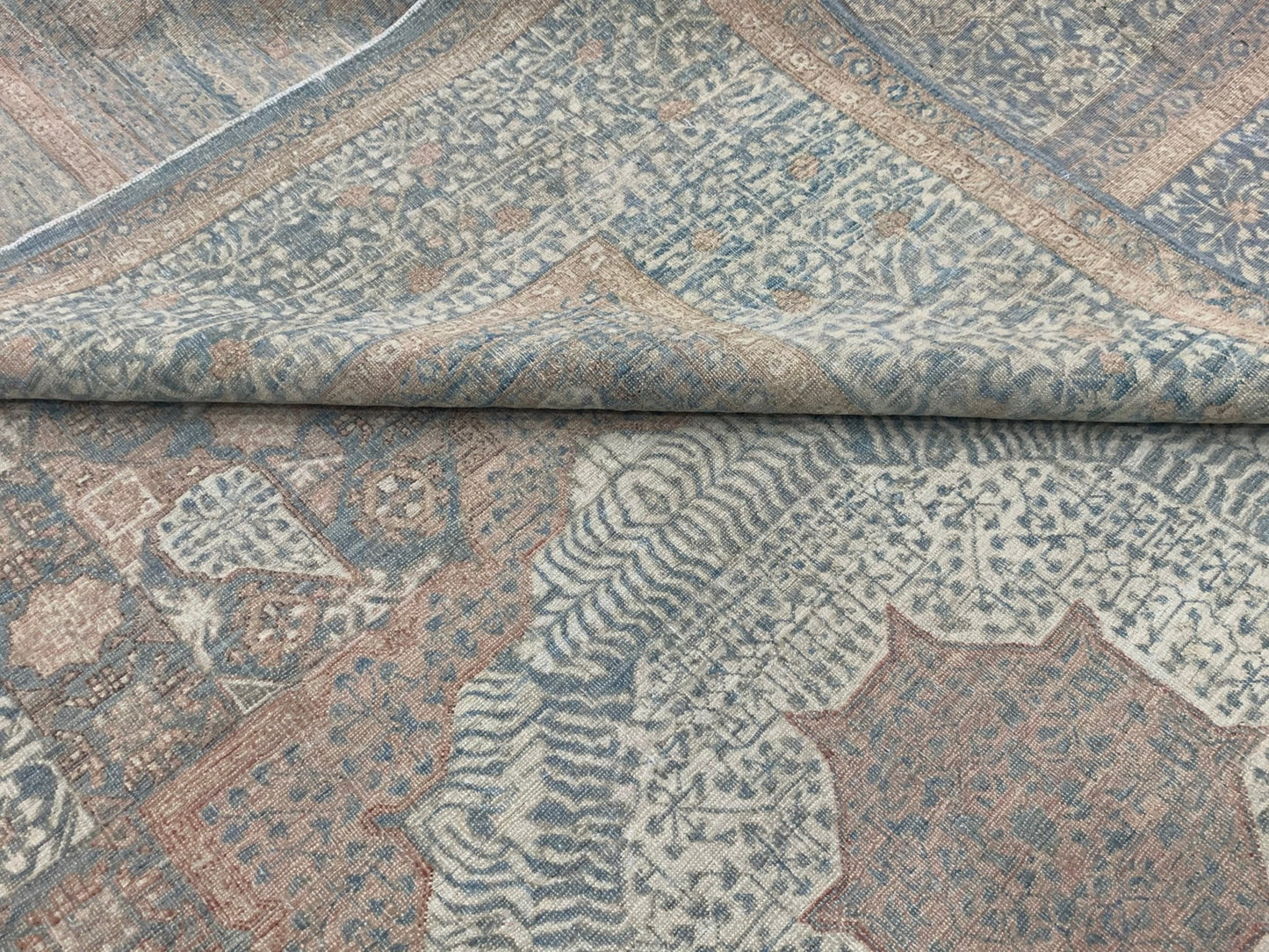 A handmade Afghan Chobi rug featuring a traditional Mamluk pattern in muted blue and tan tones.