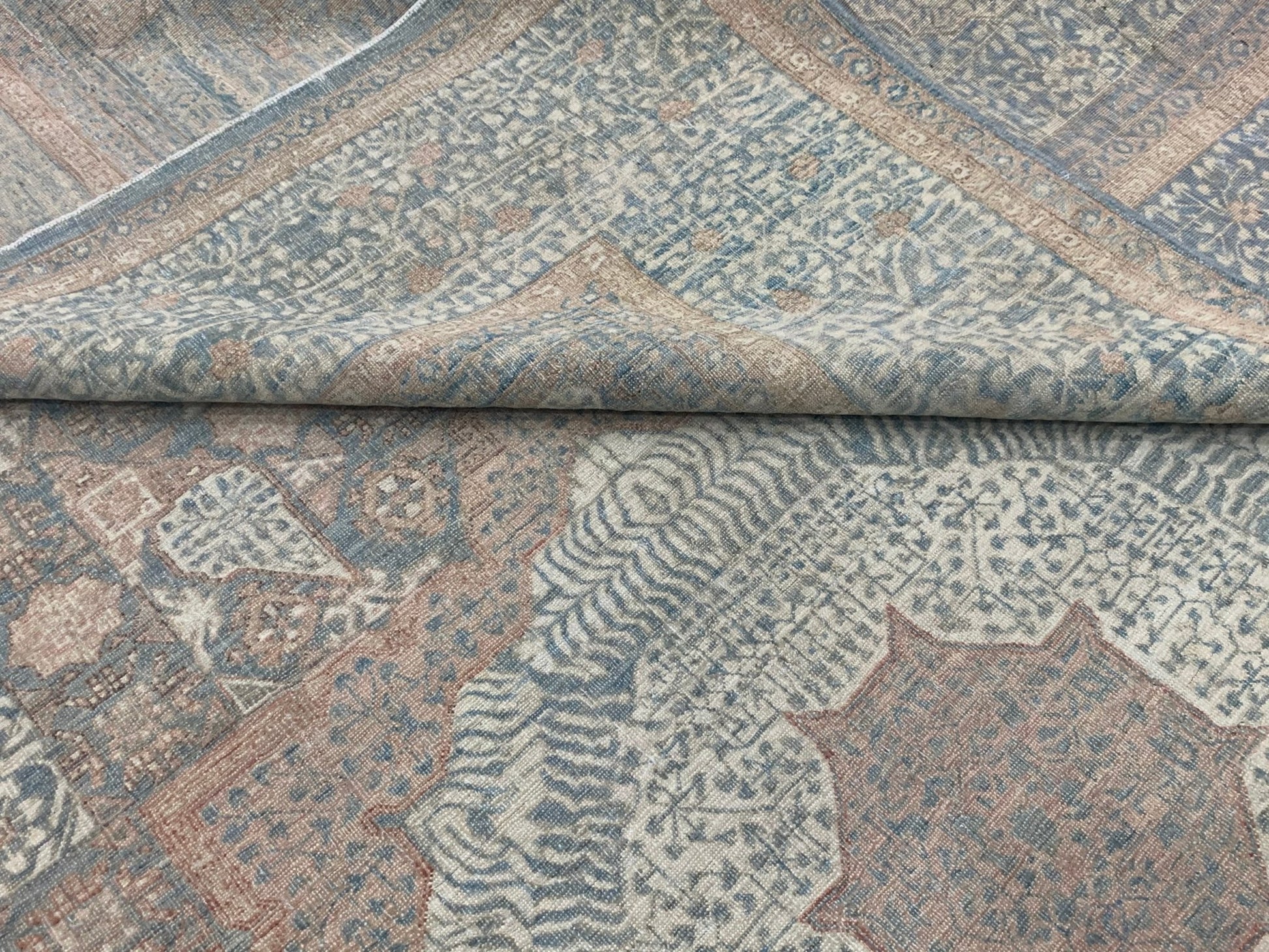 A handmade Afghan Chobi rug featuring a traditional Mamluk pattern in muted blue and tan tones.