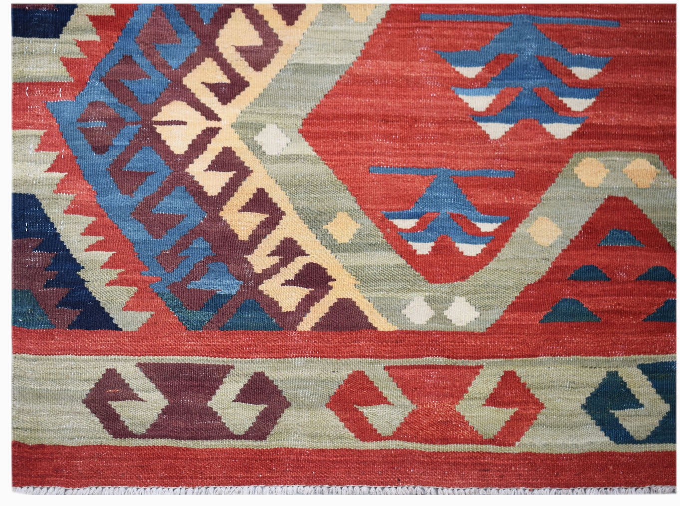 Handwoven Afghan Mazari Sharif kilim featuring geometric patterns in red, blue, and sage green.
