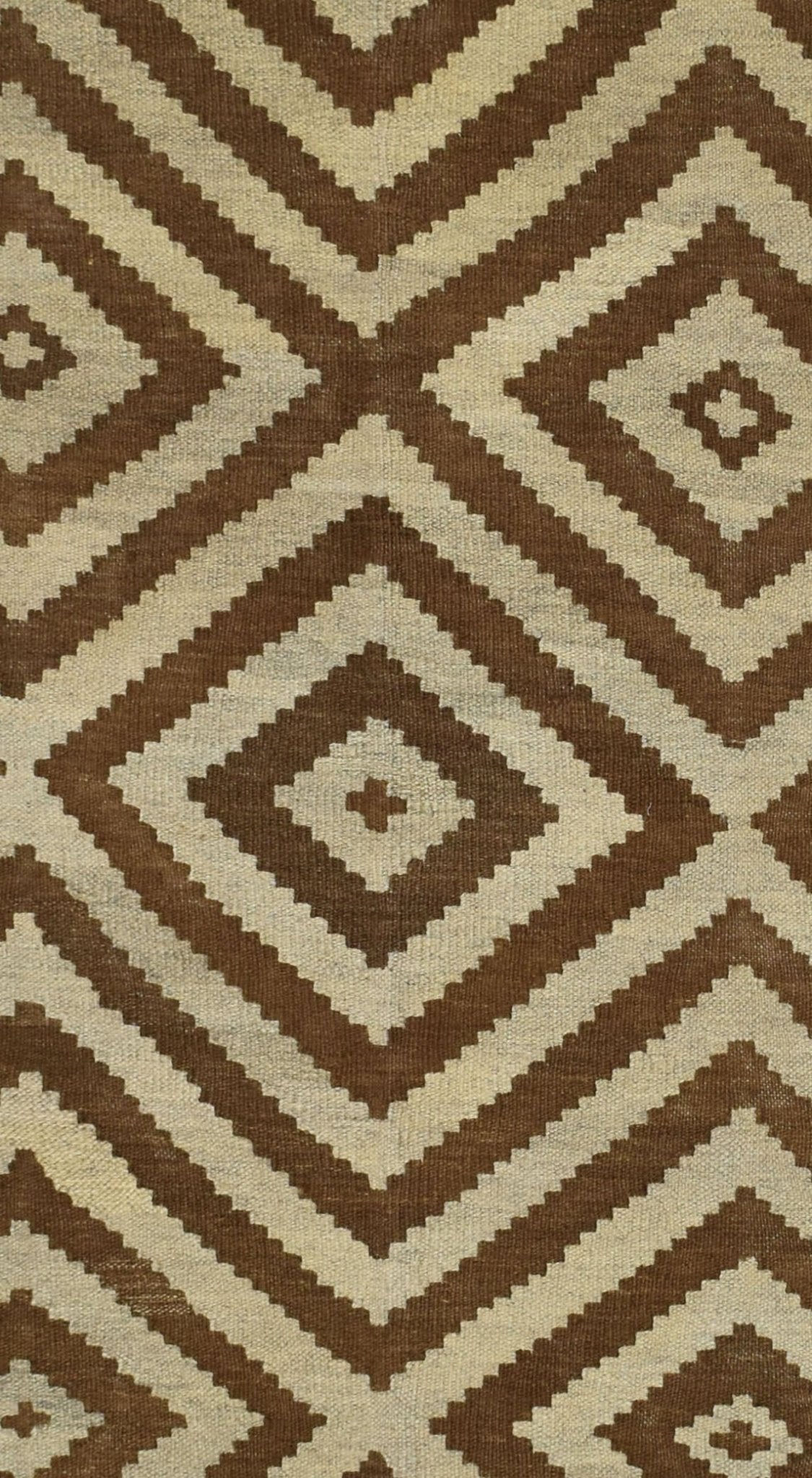 Handmade Afghan Maiamana kilim rug featuring a repeating brown and cream geometric diamond pattern.