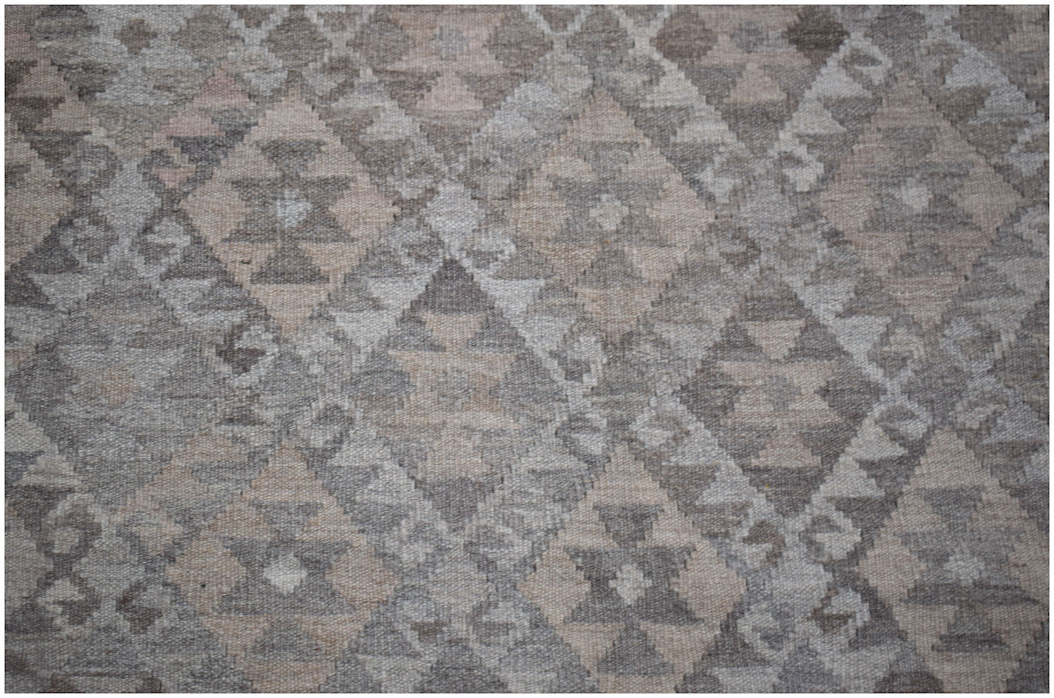 Handwoven Afghan Maimana kilim rug featuring a neutral geometric diamond pattern in natural wool.