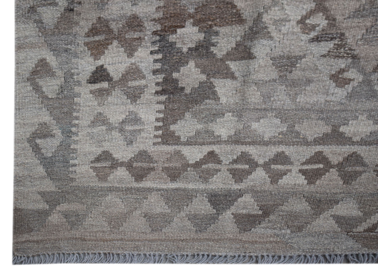 Handwoven Afghan Maiamana kilim rug featuring a geometric pattern in shades of grey and brown.