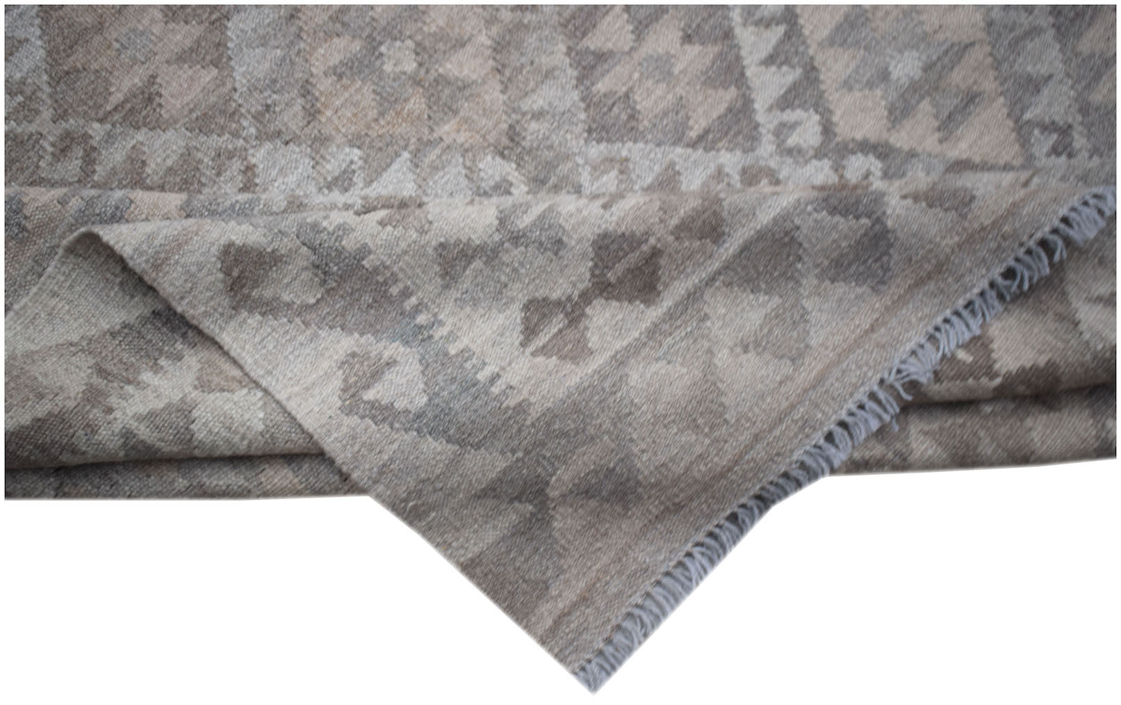 A handwoven Afghan Maimana kilim featuring a neutral geometric pattern in undyed natural wool.