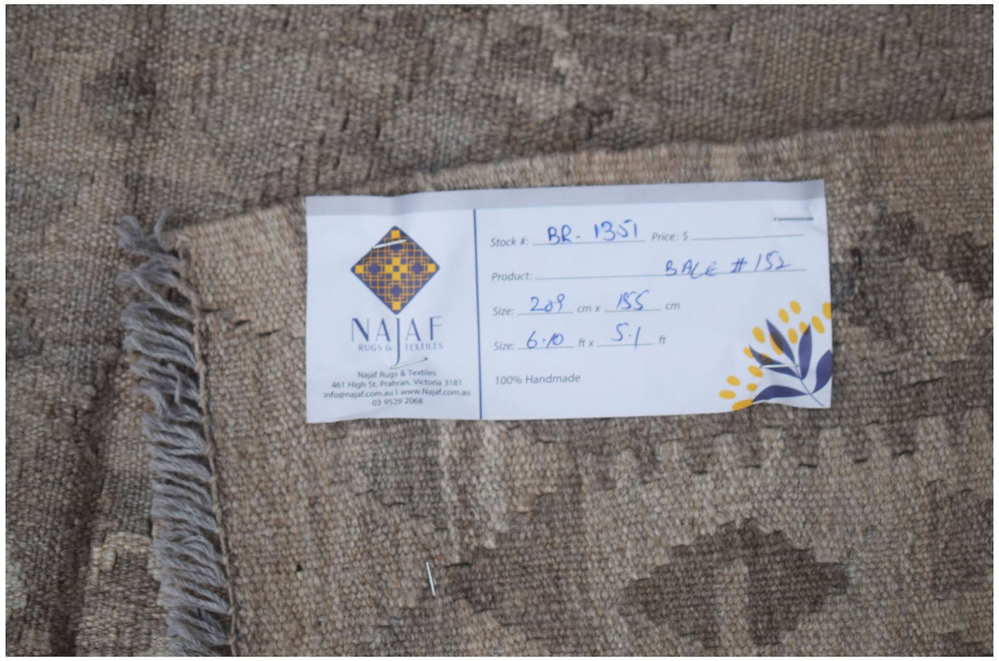 A handmade Afghan Maimana kilim rug featuring a neutral geometric pattern and flatweave texture.