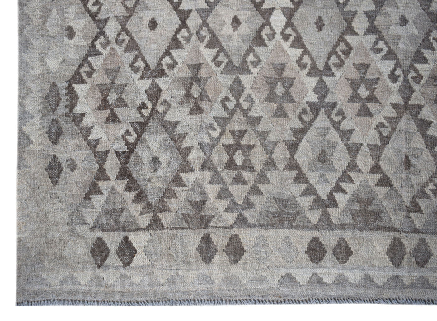 Handwoven Afghan Maiamana kilim rug featuring a grey geometric diamond pattern in natural wool.