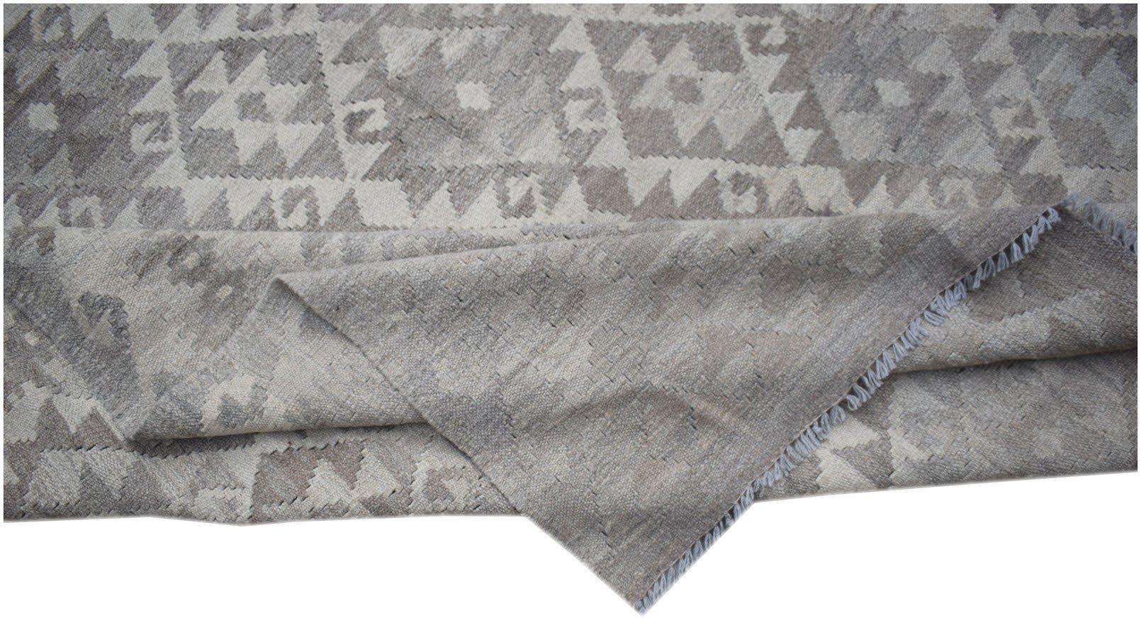 A handwoven Afghan Maiamana kilim rug featuring a grey and white geometric pattern.