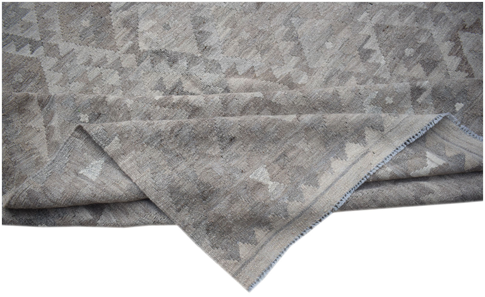A handwoven Afghan Maiamana kilim featuring a neutral geometric pattern in undyed natural wool.