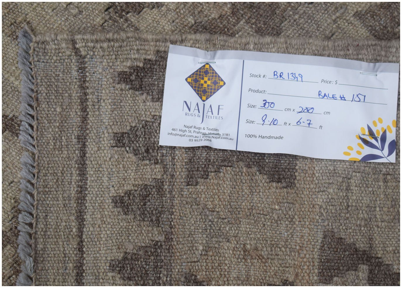 A handwoven Afghan Maimana kilim featuring a neutral geometric pattern on natural wool.
