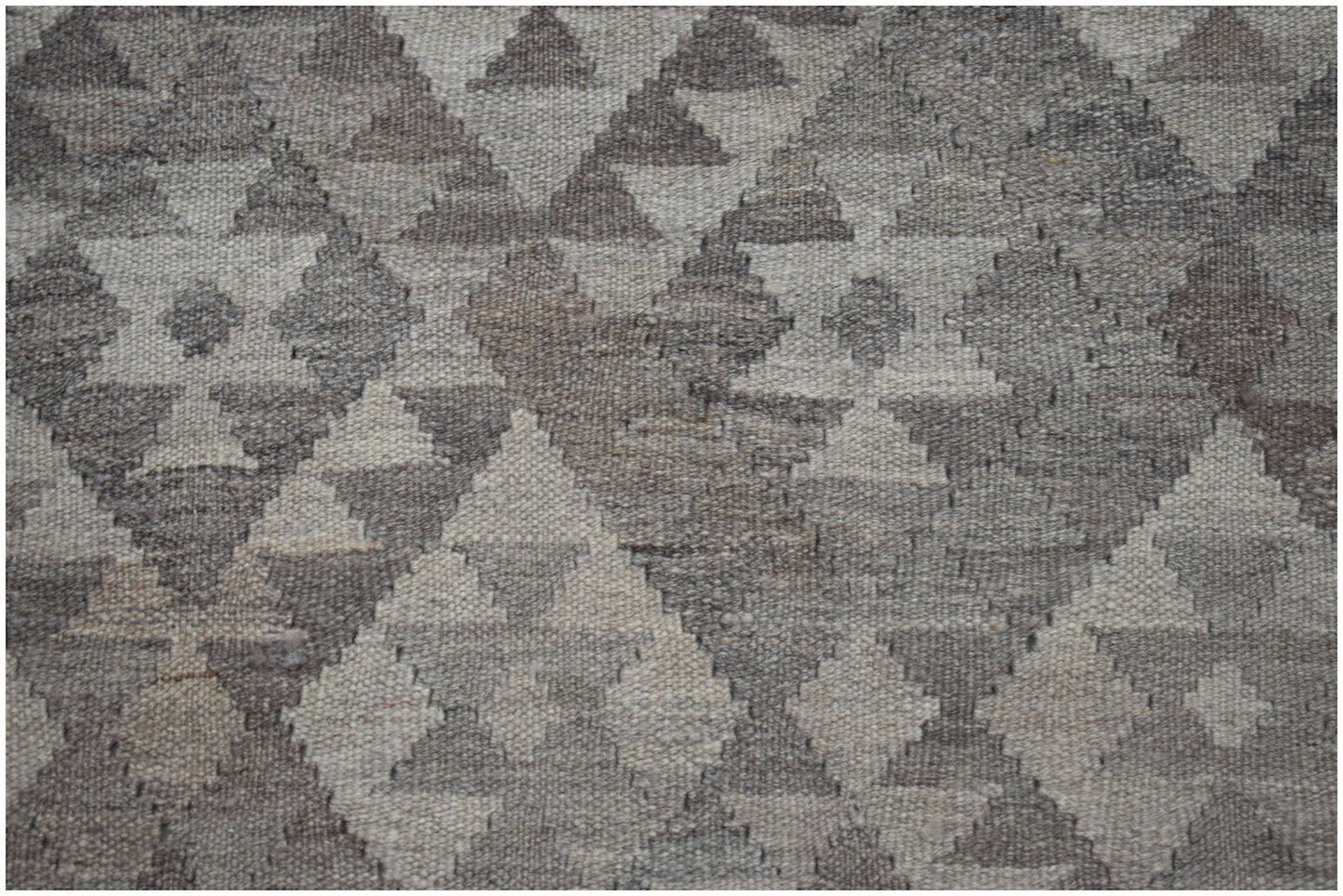 Handwoven Afghan Maiamana kilim featuring a geometric diamond pattern in natural wool tones.