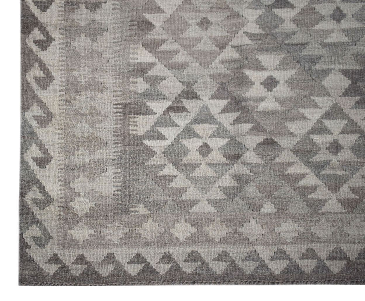 Handwoven Afghan Maimana kilim rug featuring a geometric pattern in shades of grey and white.