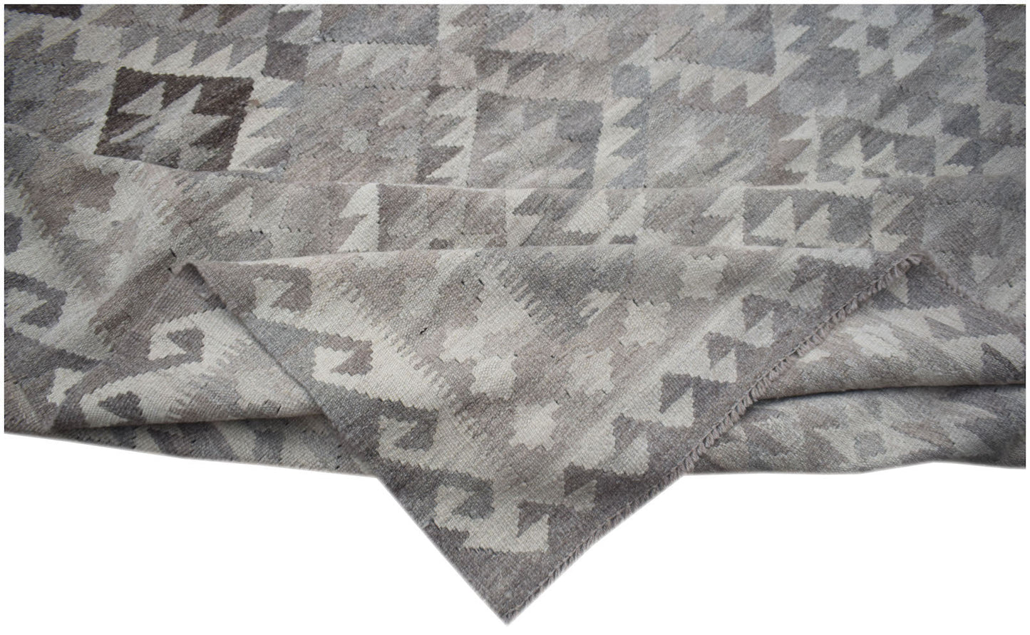 A handmade Afghan Maimana kilim rug featuring a grey and white geometric pattern in natural wool.