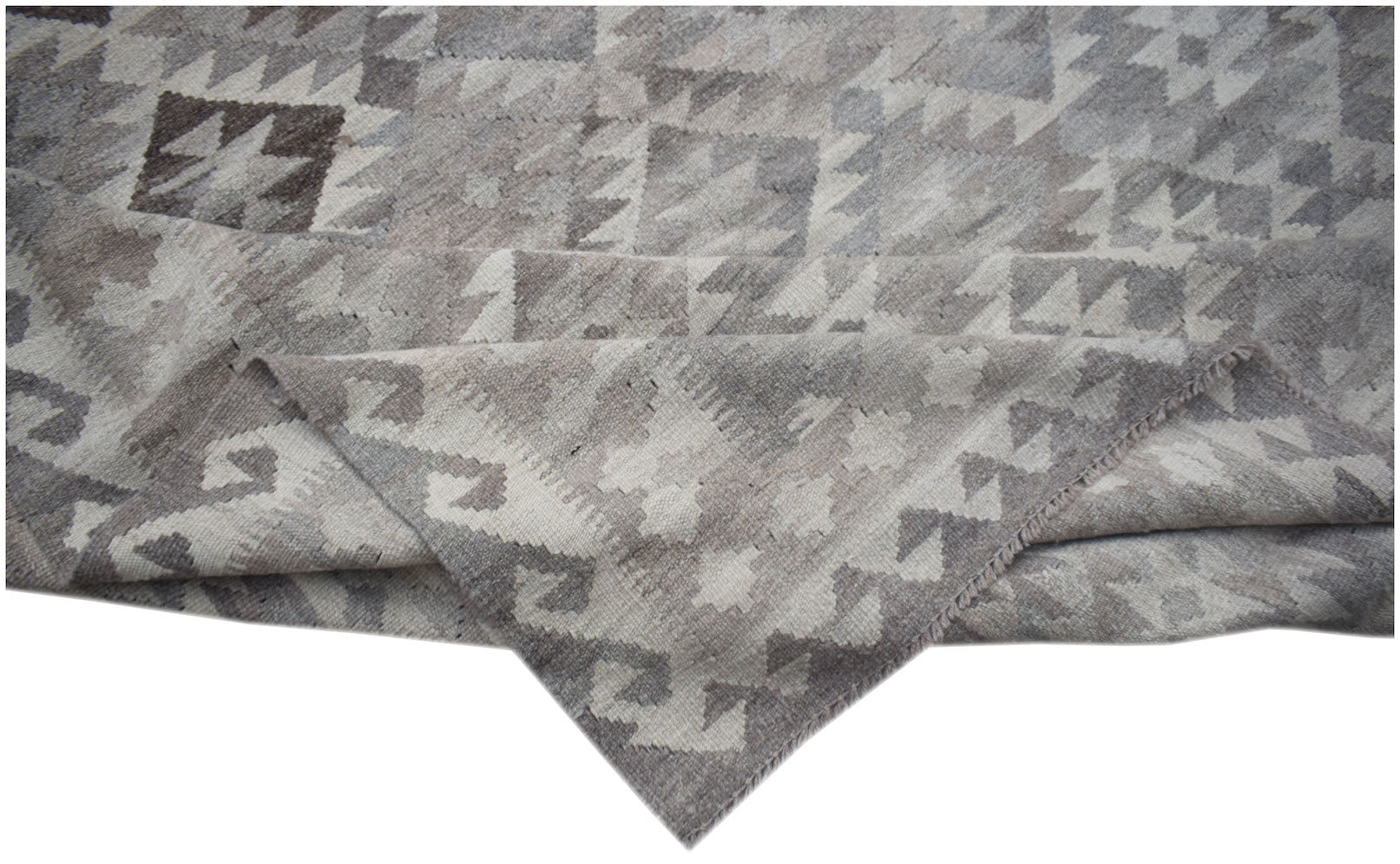 A handmade Afghan Maimana kilim rug featuring a grey and white geometric pattern in natural wool.