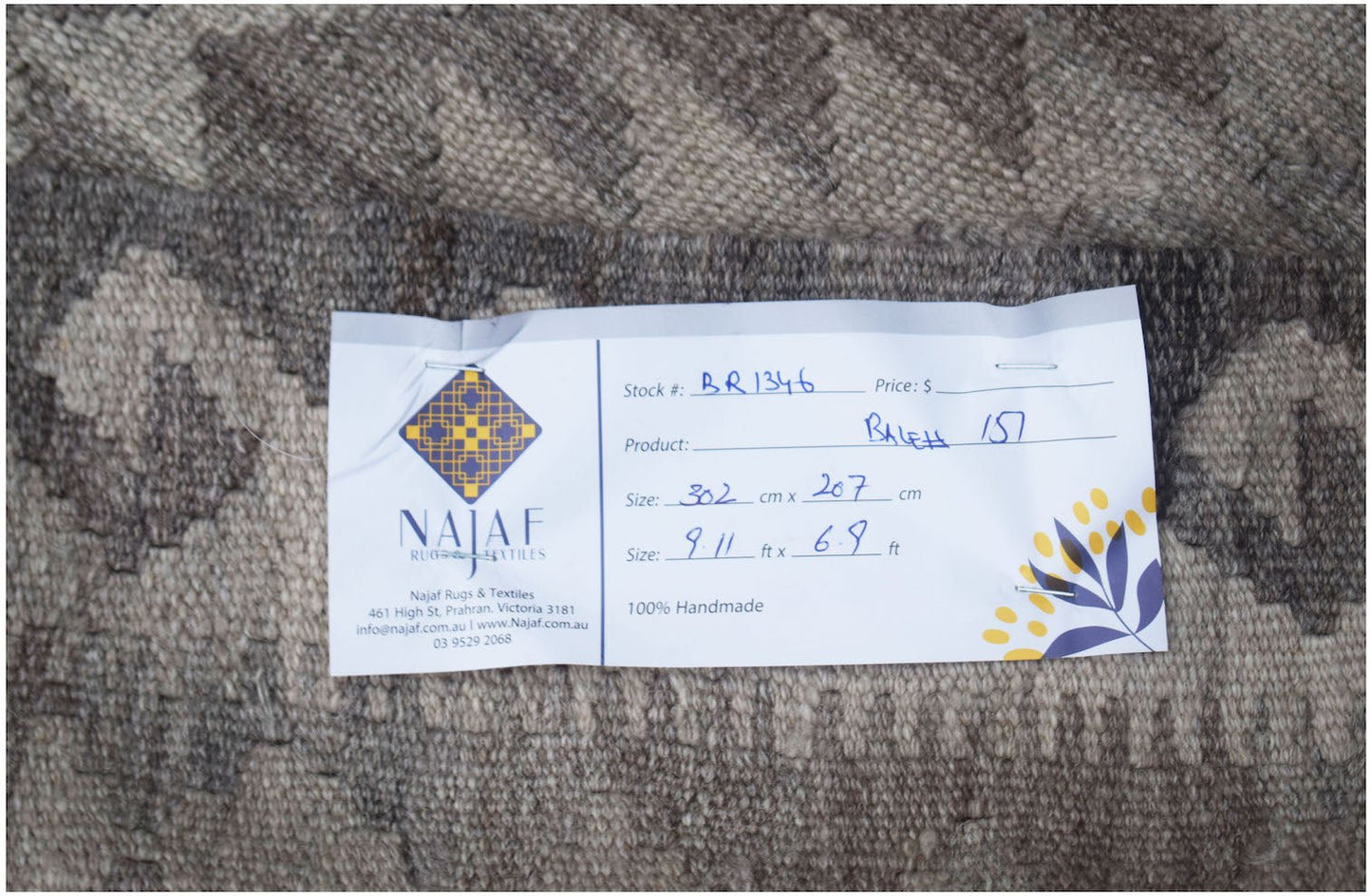 A handmade Afghan Maimana kilim featuring a neutral-toned geometric pattern.