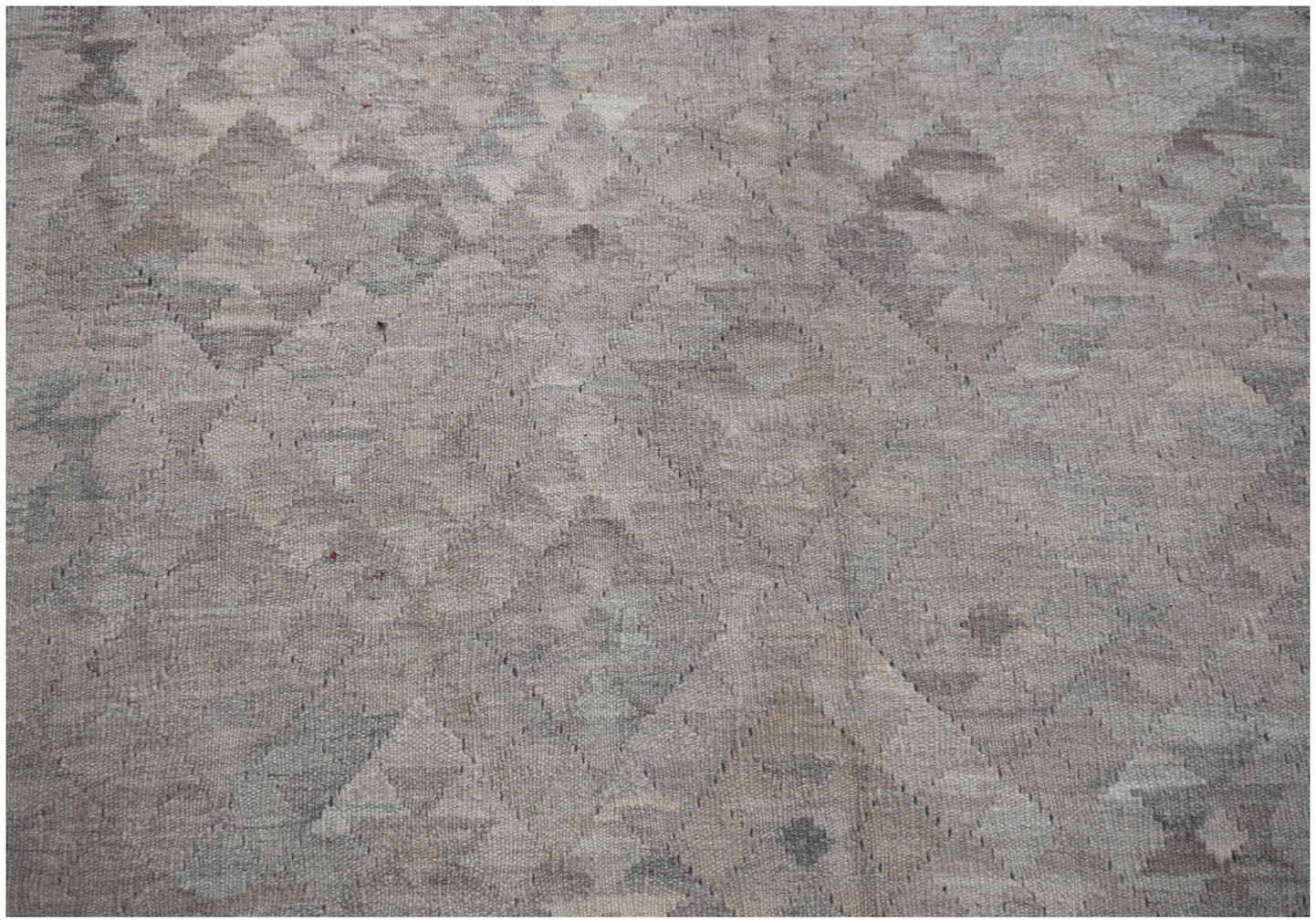 Handwoven Afghan Maimana kilim featuring a neutral-toned geometric diamond pattern in wool.