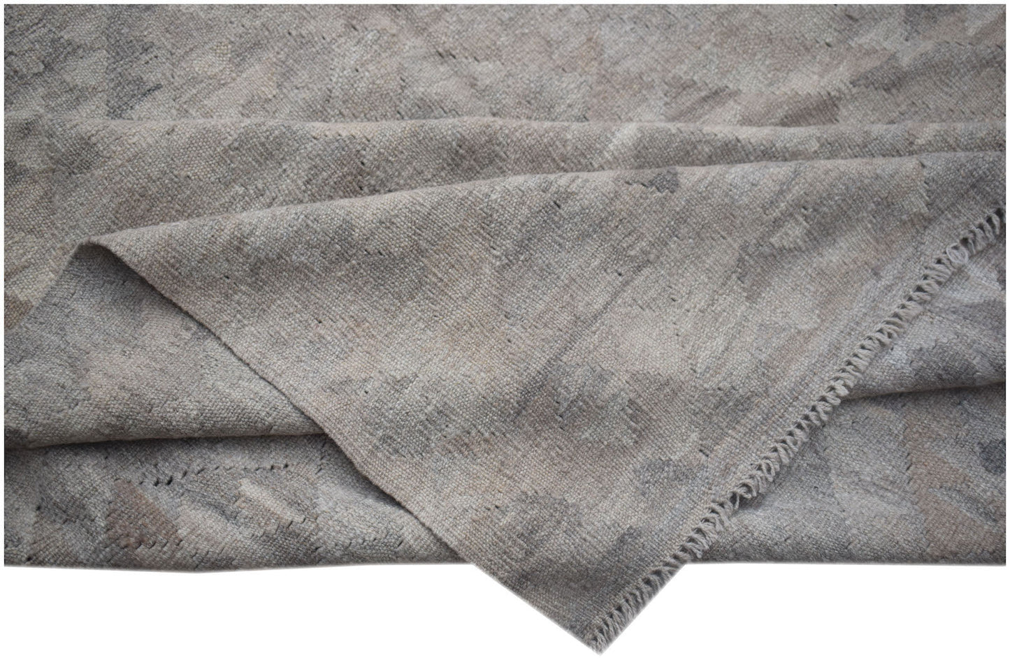A handwoven Afghan Maiamana kilim featuring a neutral, undyed wool pattern with a flat texture.