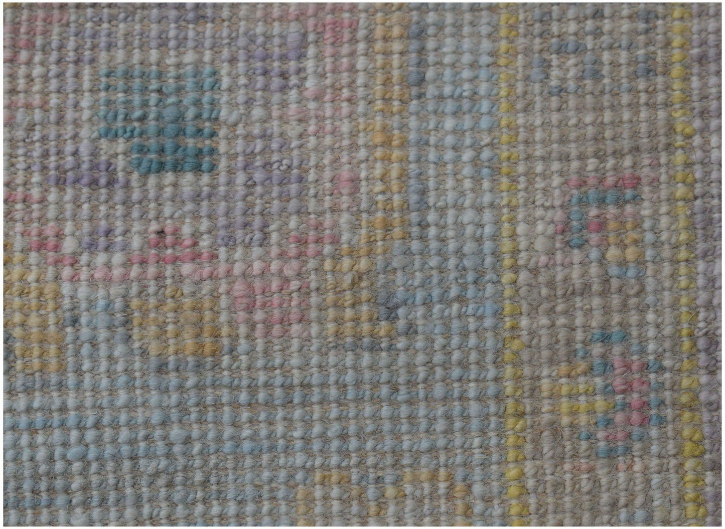 A handmade wool runner featuring a traditional Oushak pattern in soft pastel tones.