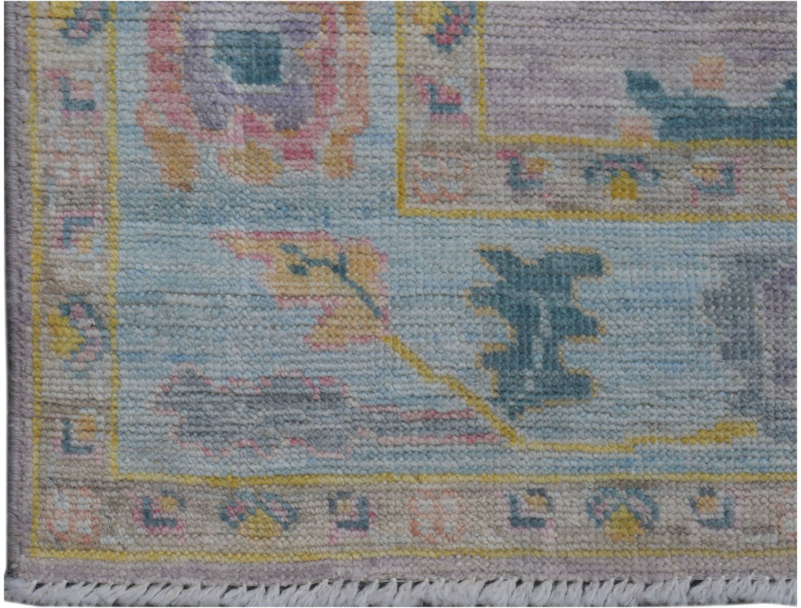 A handmade Afghan Oushak runner featuring a traditional floral pattern in soft pastel tones.